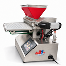 Side view of Gummy Molds 10-nozzle commercial gummy depositor showing touchscreen, servo drive, red heated hopper and mold tray